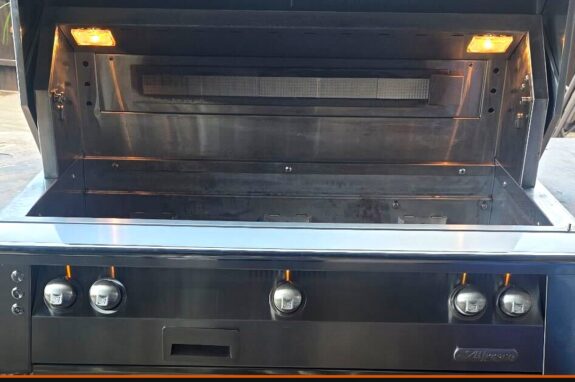 Alfresco built-in gas grill with the lid open after a professional deep cleaning