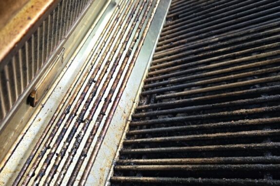 Dirty grill grates before professional cleaning