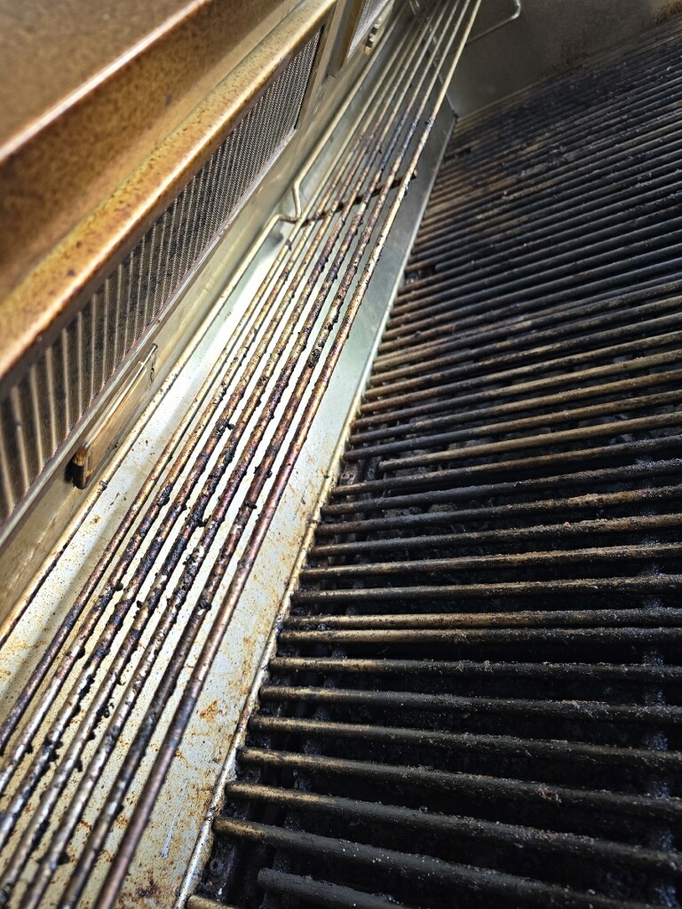 Dirty grill grates before professional cleaning