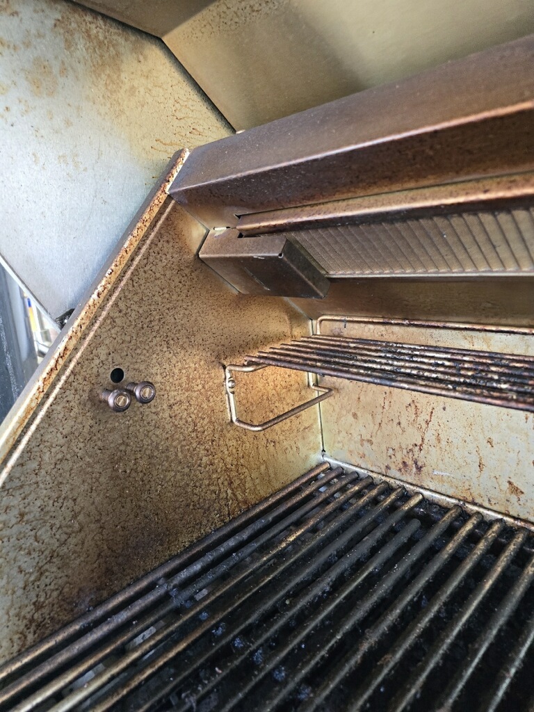 Grease and carbon buildup inside a grill before cleaning