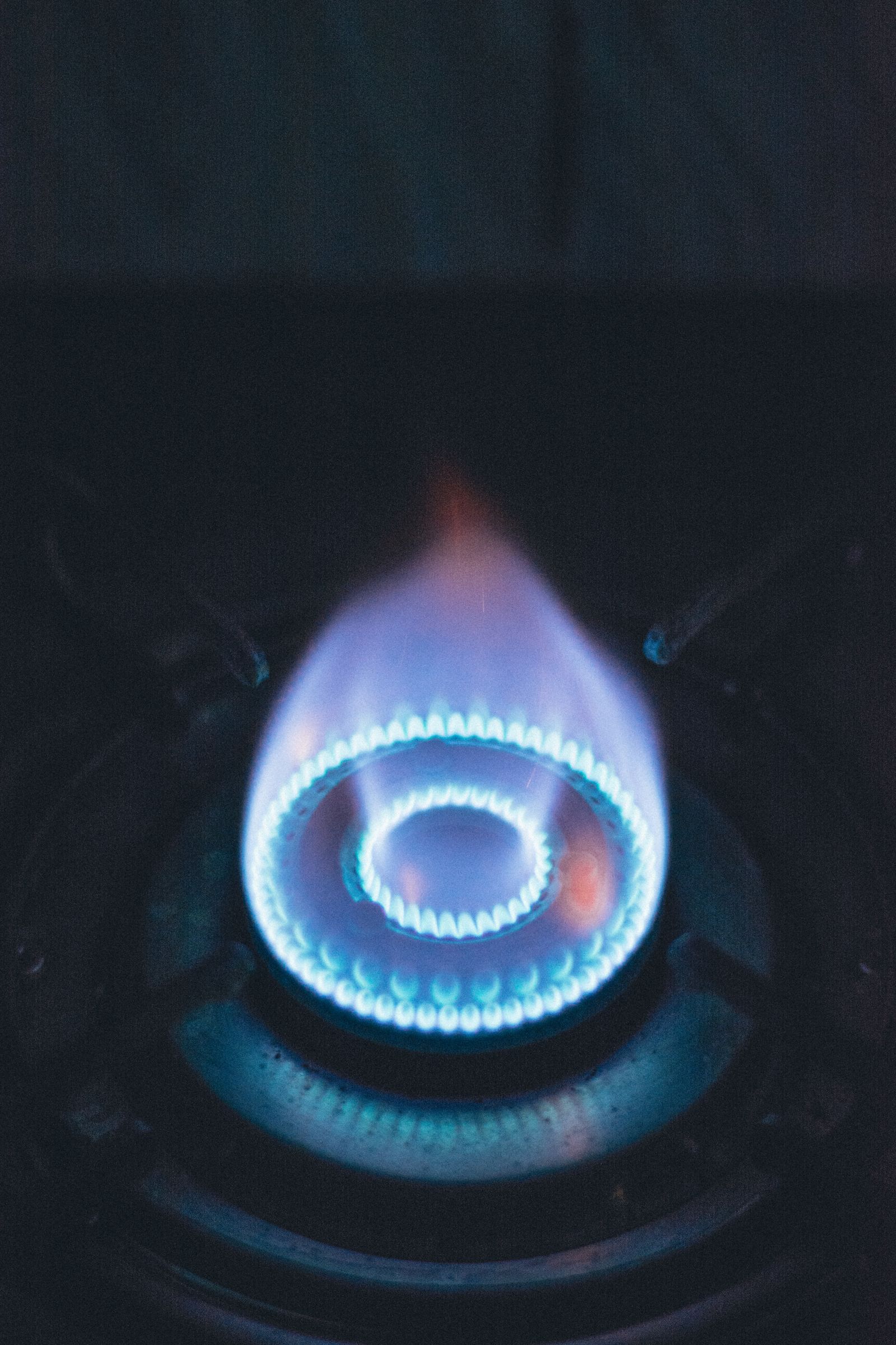 Close-up of a blue flame burning on a gas burner