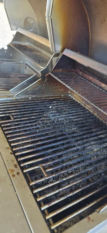 Built-in gas grill grates coated in grease and carbon before professional cleaning, DFW